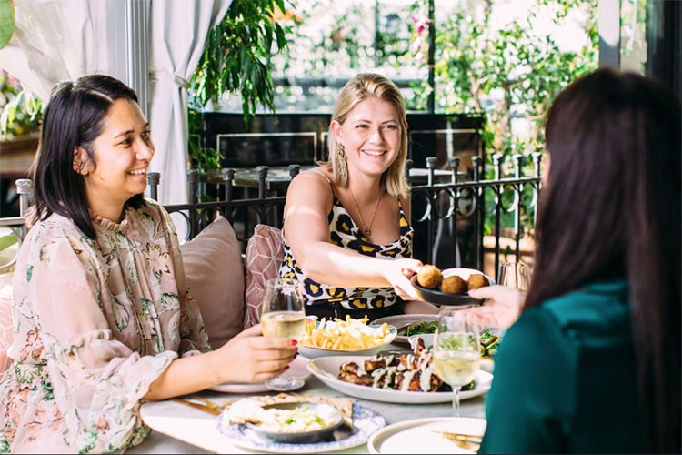 three women dining out at a restaurant enjoying lunch together
