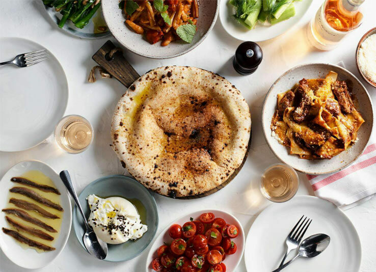 a platter of italian food sitting on the dining table